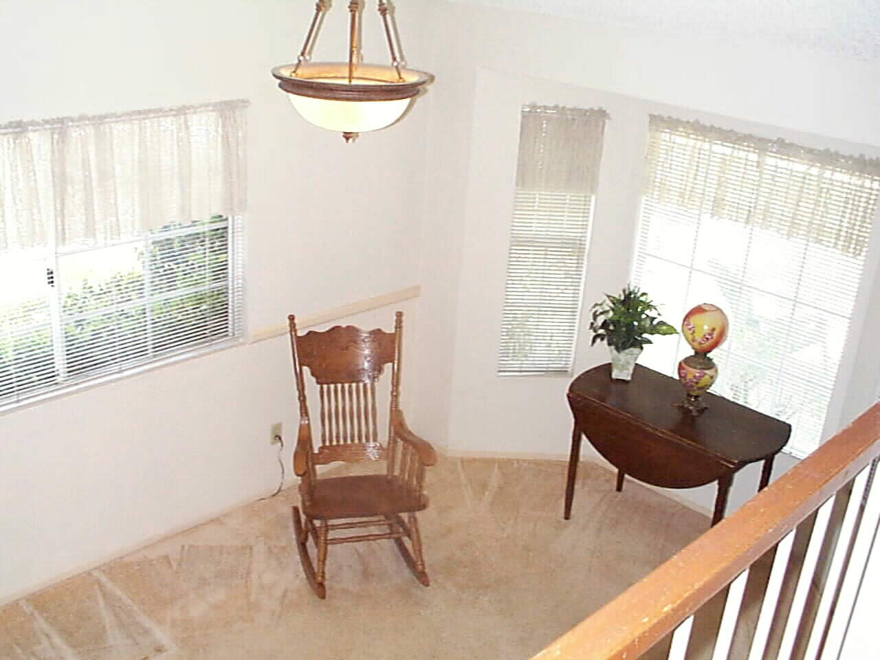 Stair-landing overlook of Spacious Dining Room with Bay Window