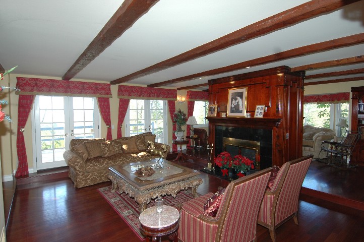 Hand Hewn Beams... French Doors... Hand carved Fireplace... and Brazilian Cherry...hardwood flooring...