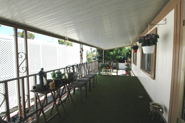 Shaded Porch Entry on this San Marcos Mobile Home for Sale