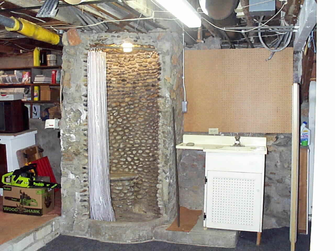 Hand Laid Carlsbad Pebble Shower in Full Walk out Basement