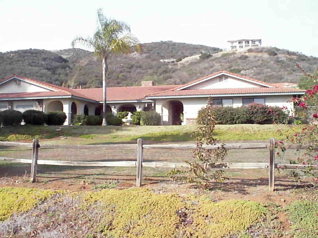 Broad eves... cool covered porch entry... nestled in the foothills of Beautiful San Marcos