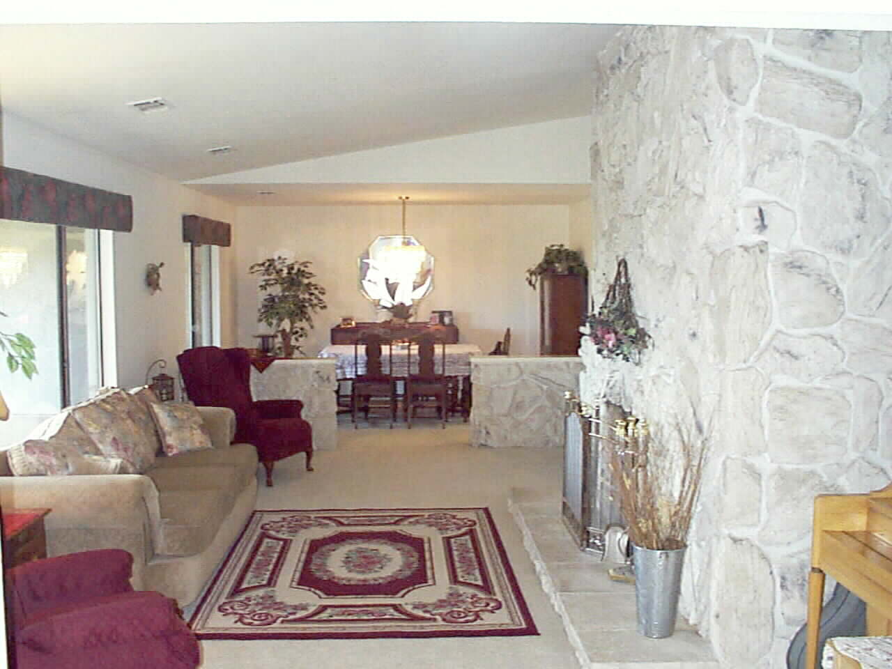 Formal Living Room and Dining Room with Elegant stone work and real Masonry Firplace.