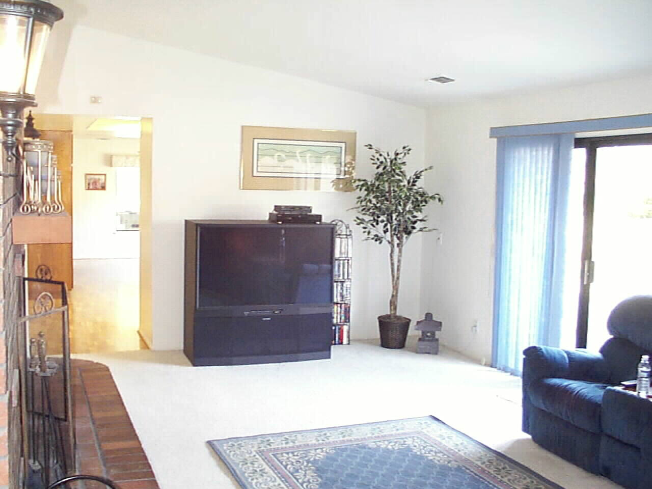 Spacious Family Room for any size entertainment center.. warmed by Masonry Brick Fireplace