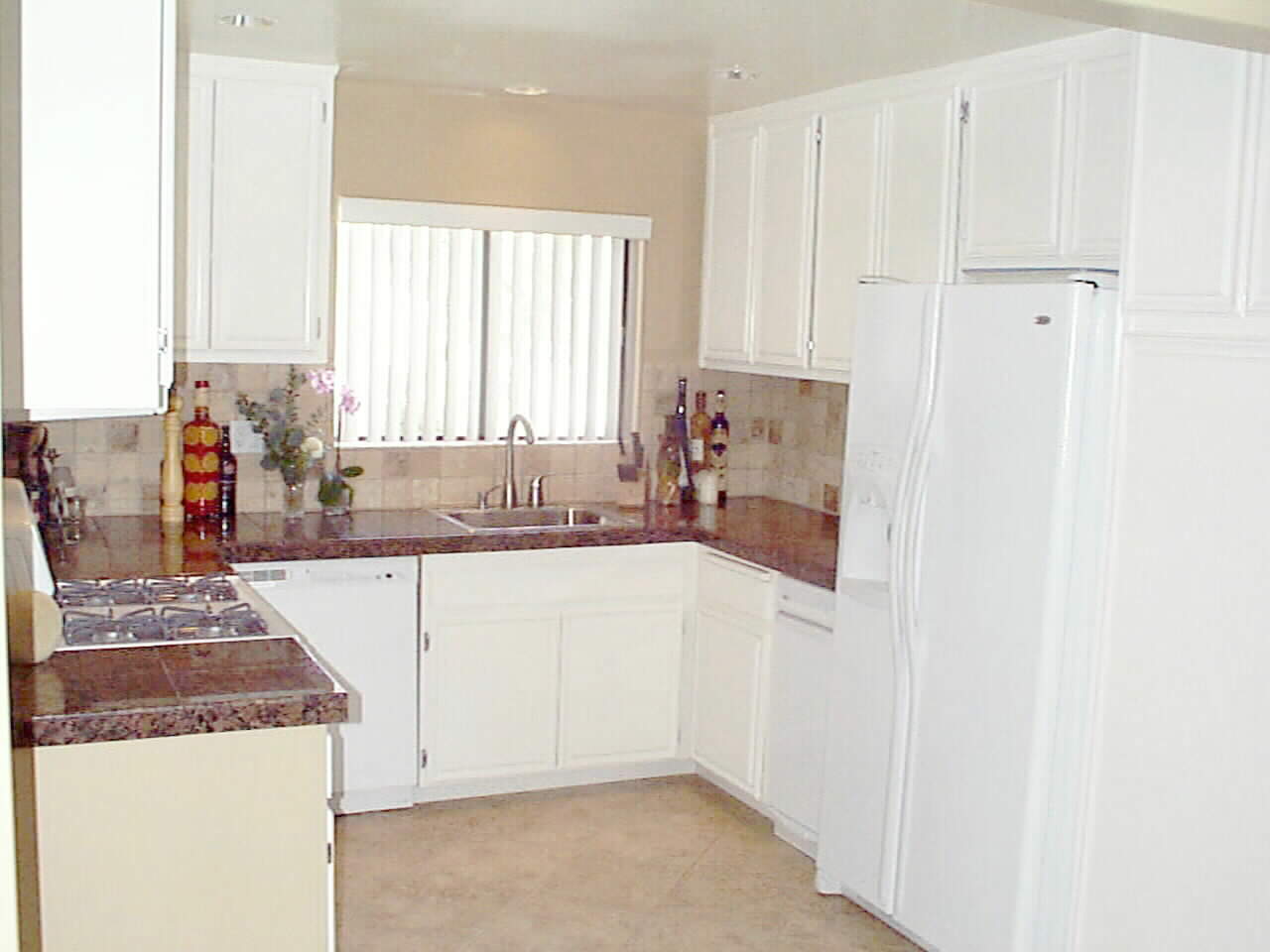 Granite Counter Tops... Desiger Mediterranean Tile... and Beautiful Accent Lighting